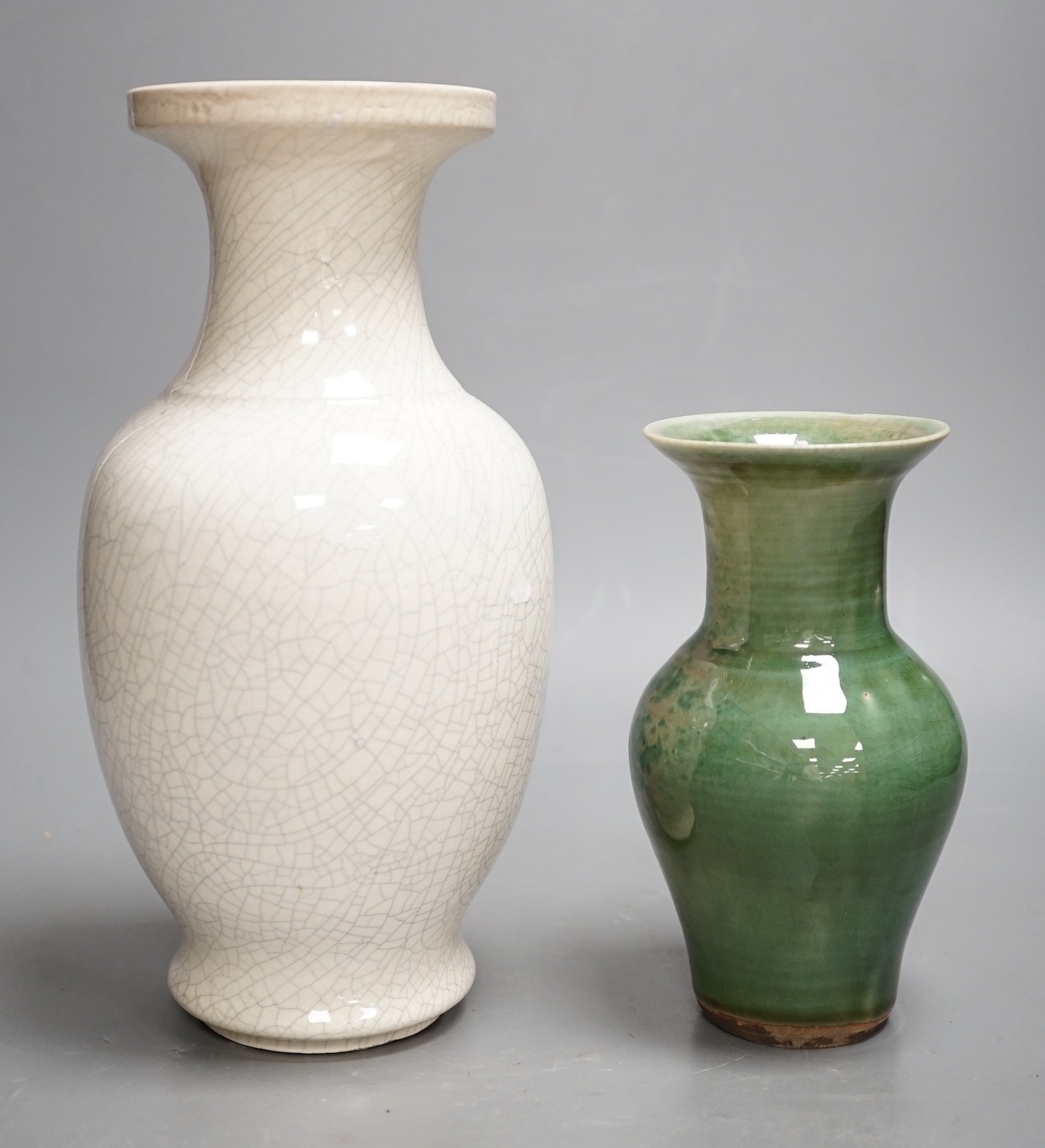 A Chinese white crackleware vase and a smaller green glazed vase